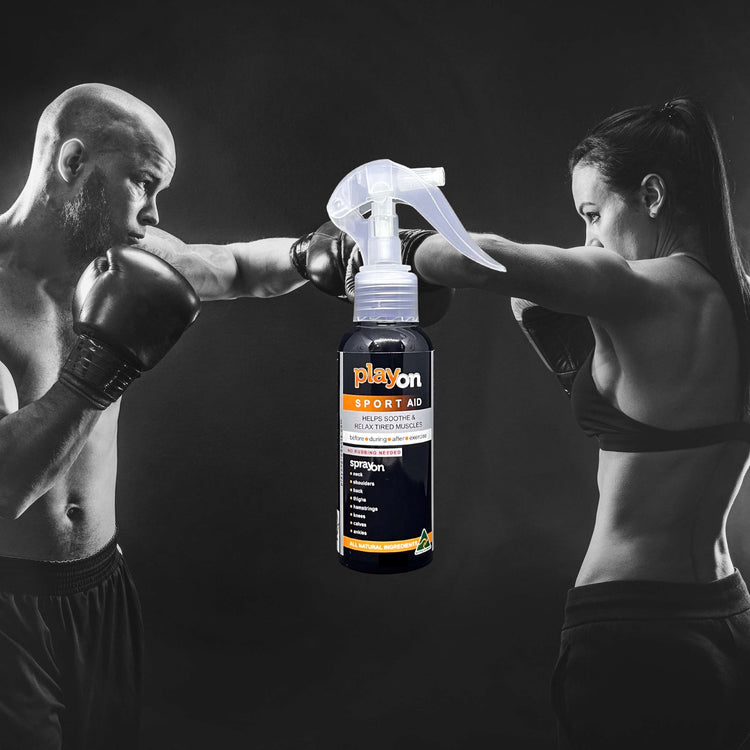 Woman boxing with male trainer, PlayOn SPORTS spray bottle in focus – natural body care for active lifestyles