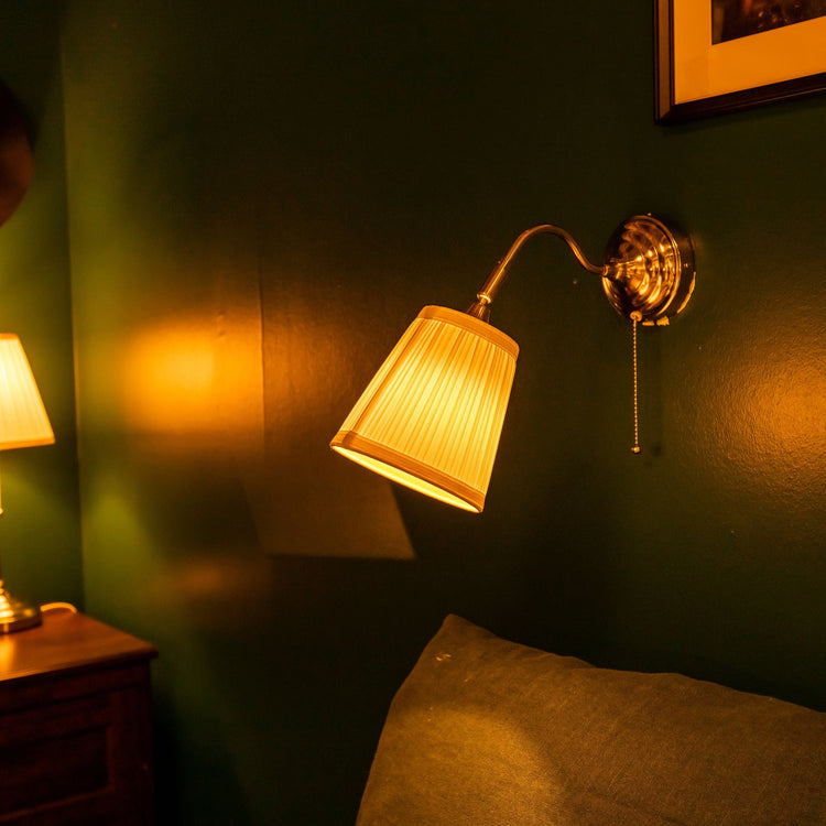 Warm bedroom lamp casting a soft glow, creating a relaxing and cozy atmosphere