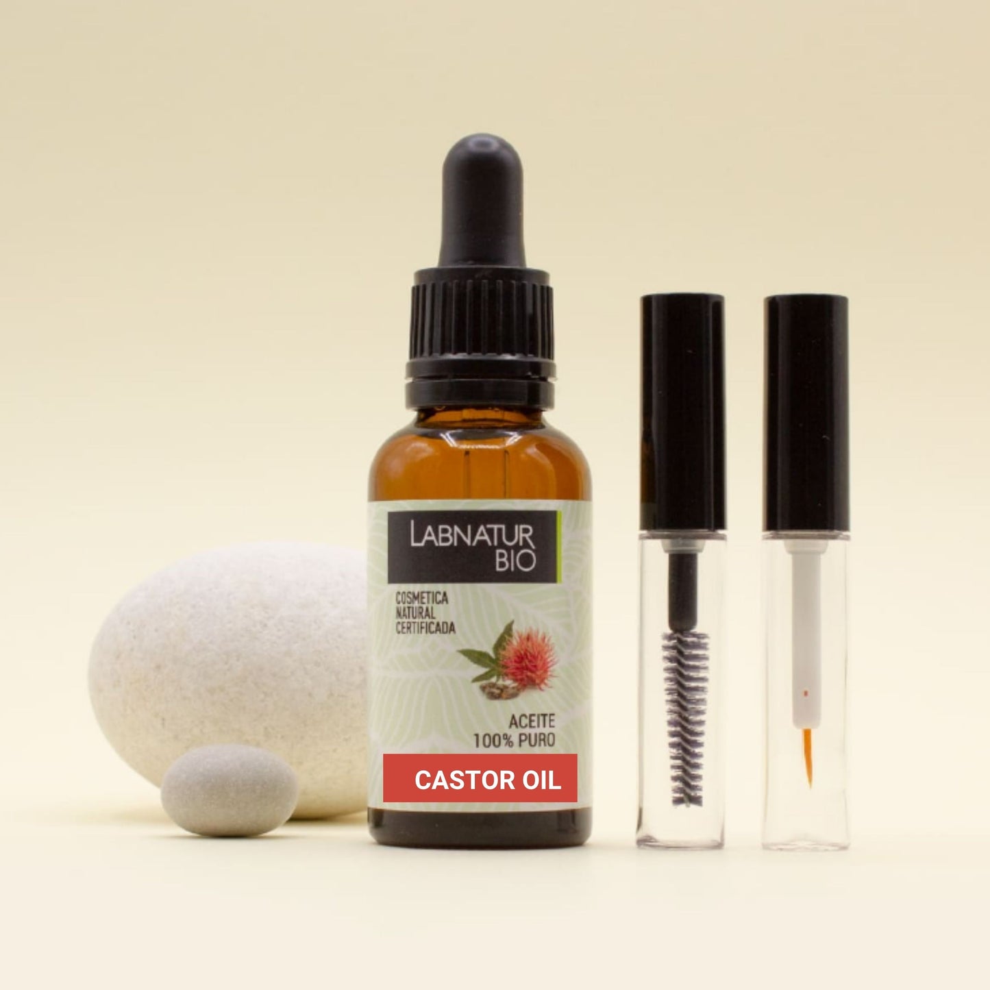 Bottle of Labnatur Bio castor oil with dropper and applicator on a beige background