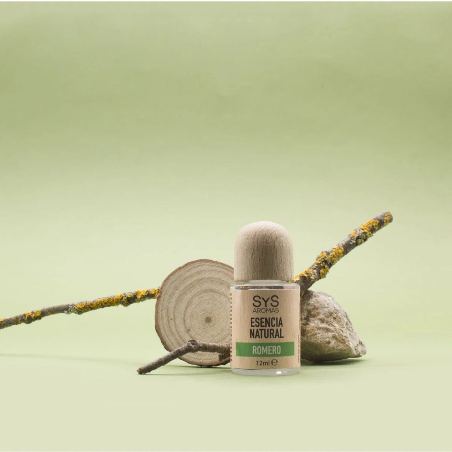 Bottle of natural rosemary essential oil with a wooden cap on a green background