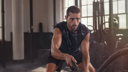 man wokring out in gym with rope