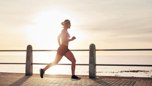 woman running outside near the water