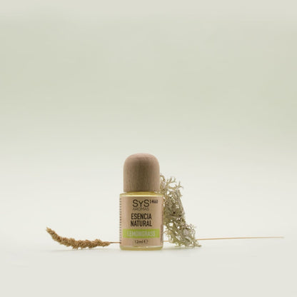 Lemongrass Essential Oil Bottle labelled with 'Natural Essence' with a dried plant on a light background