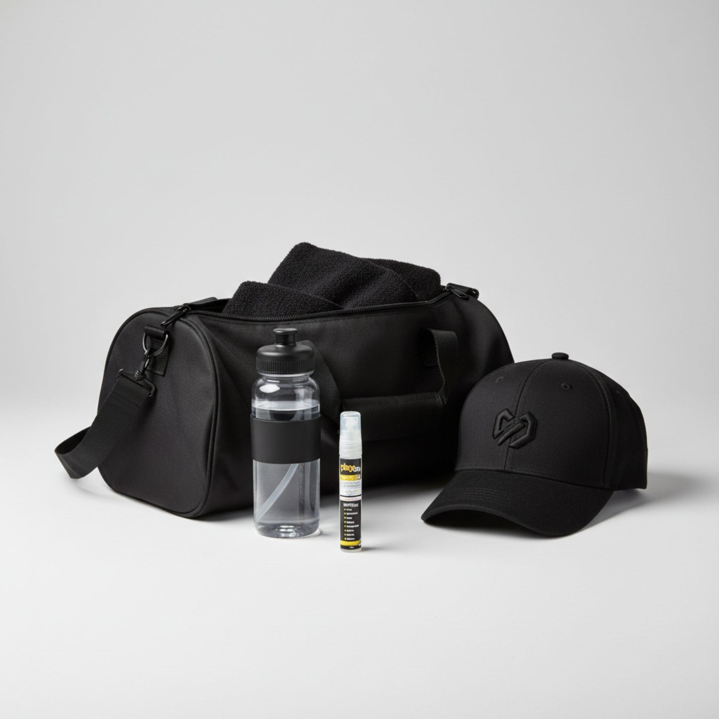 Black duffel bag with a cap, water bottle, and playon spray mini n a white background.