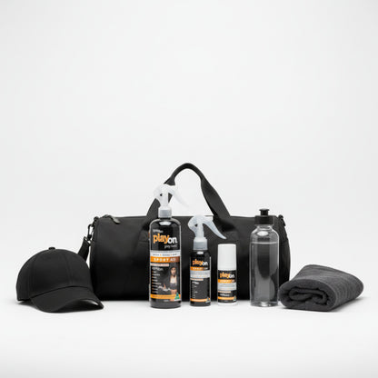 Black duffel bag with a cap, bottles, playon refill, playon spray and playon roll on on a white background.