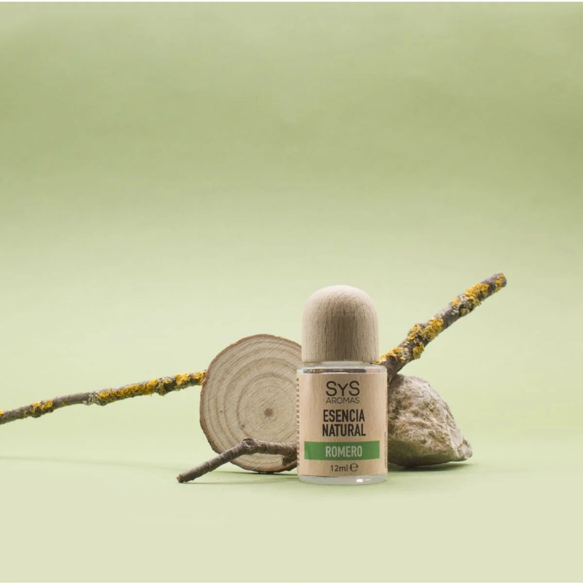 Bottle of natural rosemary essential oil with a wooden cap on a green background