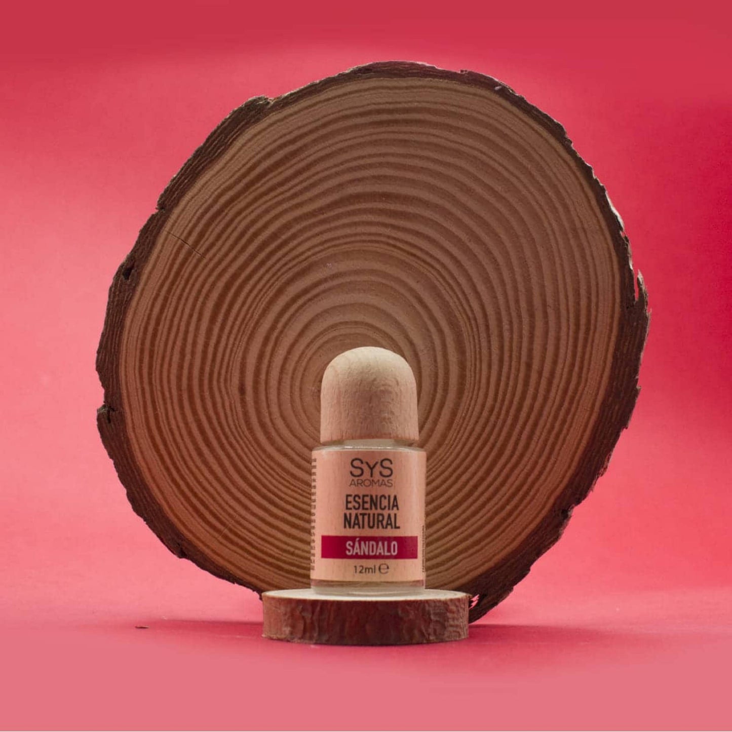 SyS Aromas Sandalwood Essence 12ml bottle styled with a piece of natural sandalwood.
