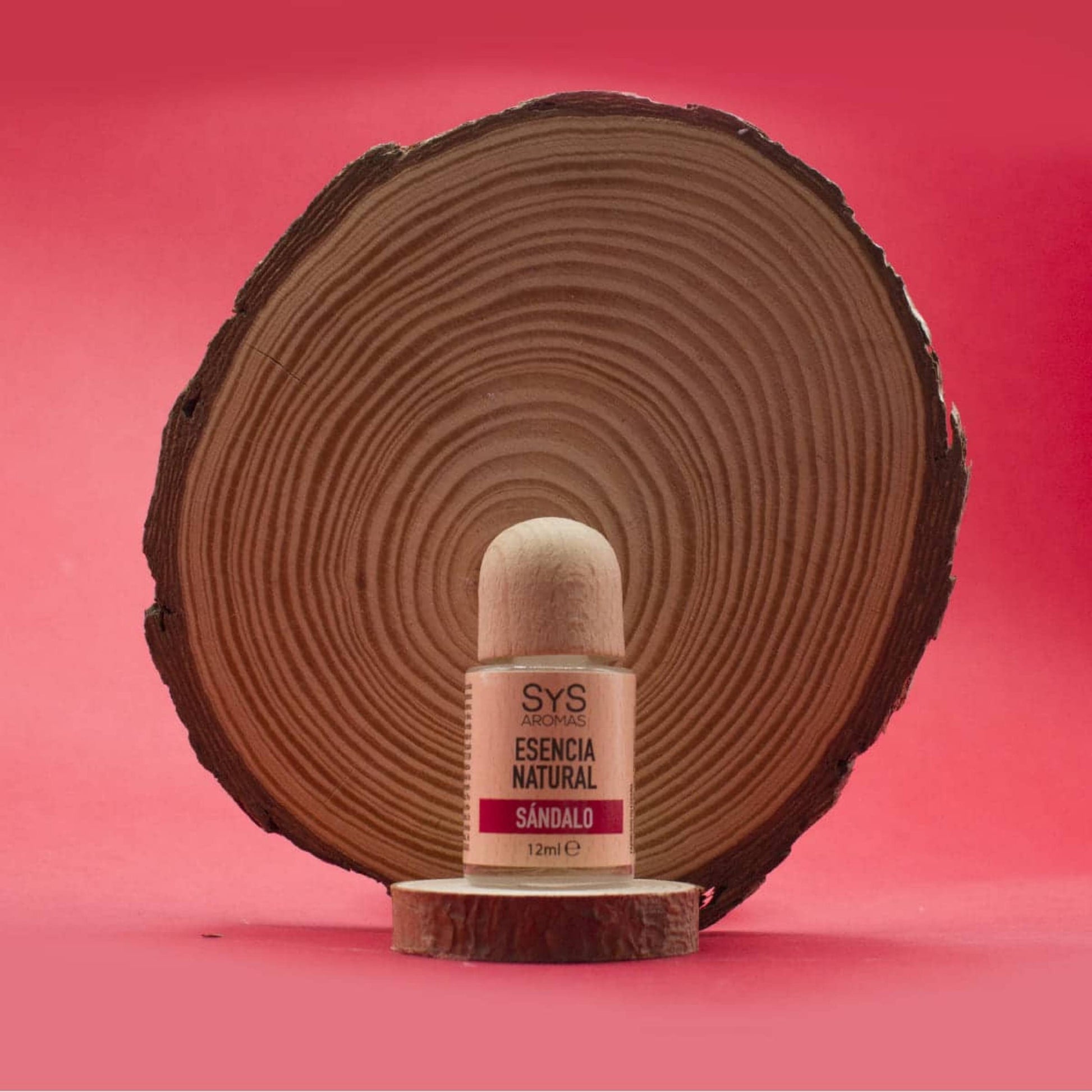 SyS Aromas Sandalwood Essence 12ml bottle styled with a piece of natural sandalwood.