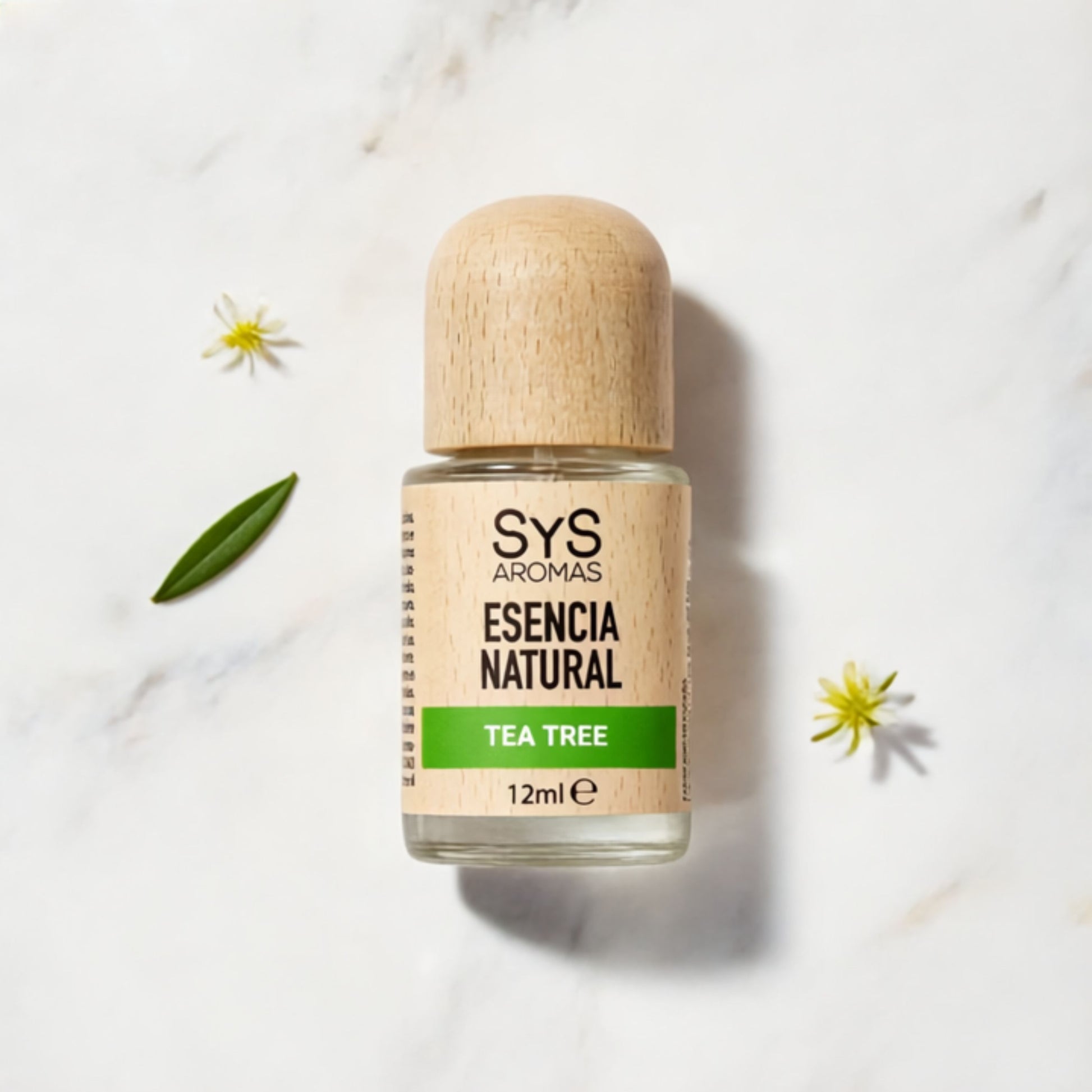 Bottle of Tea Tree essential oil 12ml on a light background with flowers.