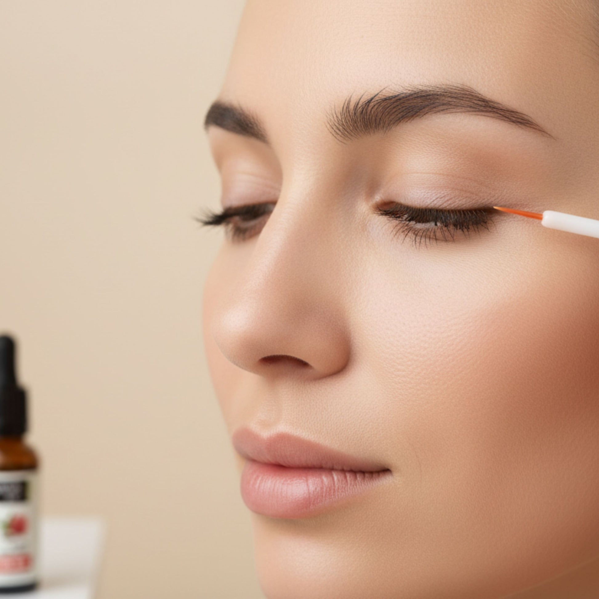 woman applying castor oil to eyelashes with eyelash wand