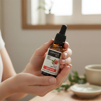 Woman holding a bottle of Castor Hair Oil in a relaxing setting